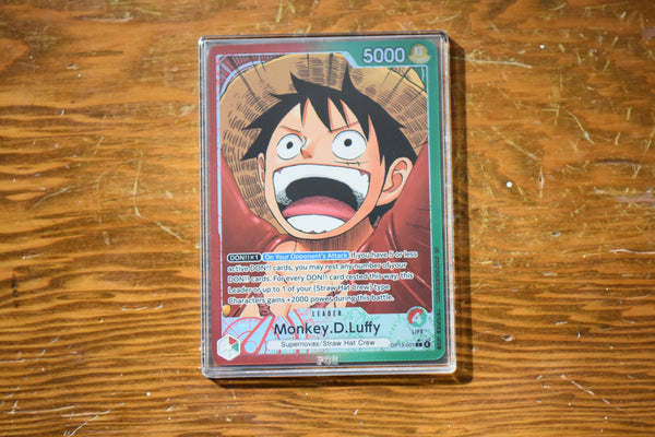Detailed view of an OP13 Luffy Alt Art Leader encased in a PCG Slim Player Slab.
