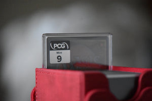 Cloud Ex-SOLDIER PCG 9 Mint in a Slim Player Slab next to a red deckbox - back view