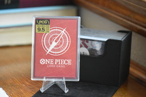 Doflamingo Alt Art PCG 9.5 in a Slim Player Slab next to black Sidewinder deckbox - back of card.