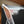 Side view of a Doflamingo Alt Art Leader in a PCG Slim Player Slab with blurry background.