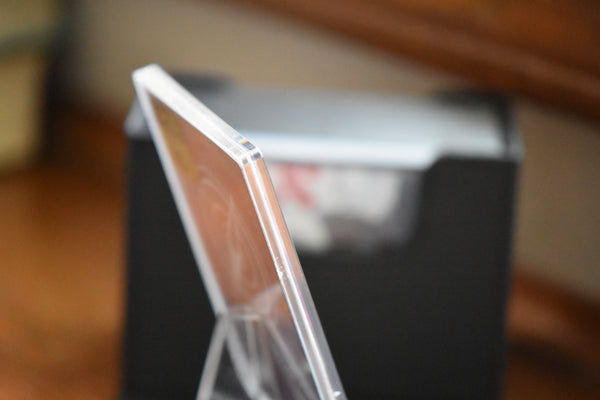 Side view of a Doflamingo Alt Art Leader in a PCG Slim Player Slab with blurry background.