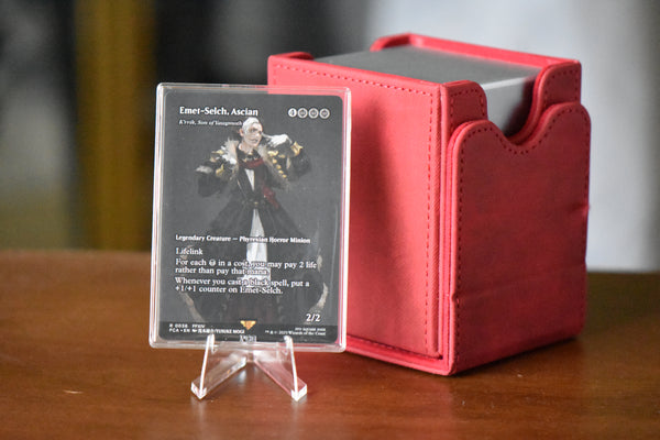 Emet-Selch PCG 9.5 Gem Mint in a Slim Player Slab next to a red deckbox - front