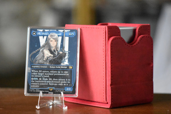 Jill Shiva's Dominant PCG 9.5 Gem Mint in a Slim Player Slab next to red deckbox - front view