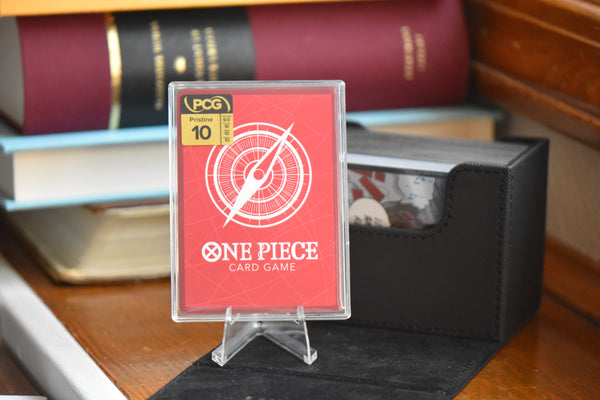 Jinbe Alt Art in a PCG 10 Pristine Slim Player Slab next to a black deckbox - back view.