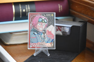 Koby Alt Art PCG 10 in a Slim Player Slab next to a black deckbox - front view.