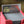 Lightning Borderless PCG 10 Gem Mint in a Slim Player Slab inside a red deckbox - back view