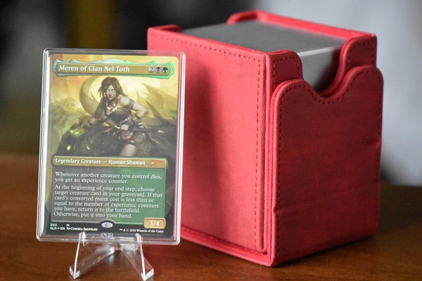 Meren Borderless PCG 9 Mint in a Slim Player Slab next to a red deckbox - front view