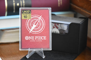 Newgate Alt Art PCG 10 in a Slim Player Slab next to a black deckbox - back view.