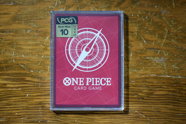 Backside of an OP13 Luffy Alt Art PCG 10 in a Slim Player Slab with grade details.