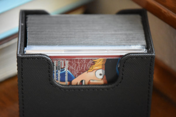 Graded Sabo OP13 Alt Leader inside a black Ultimate Guard Sidewinder along with a One Piece deck.