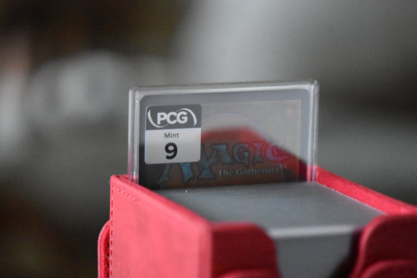 Torbran SLD 678 PCG 9 Mint in a Slim Player Slab next to a deckbox - back view