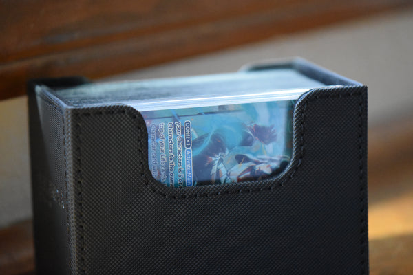 Trafalgar Law Alt Art Leader in a Slim Player Slab inside a black Ultimate Guard Sidewinder deckbox.