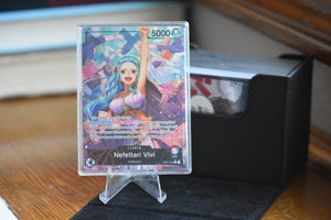 Vivi Alt Art PCG 10 Pristine in a Slim Player Slab next to a black deckbox - front.