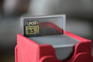 Yshtola Rhul PCG 9.5 Gem Mint in a Slim Player Slab next to a deckbox - back view